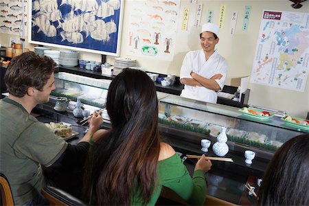 sushi restaurant - People eating at sushi bar Stock Photo - Premium Royalty-Free, Code: 693-03686491