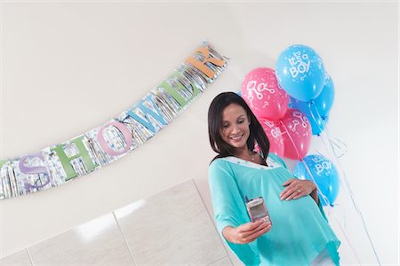 simsearch:693-06017192,k - Pregnant Woman with Her New Baby Monitor at baby shower Stock Photo - Premium Royalty-Free, Code: 693-03686524