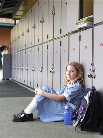 simsearch:693-03314791,k - Elementary schoolgirl sitting on floor against school lockers, portrait Stock Photo - Premium Royalty-Free, Code: 693-03686642