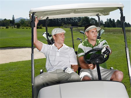 sun visor hat - Two young male golfers sitting in cart Stock Photo - Premium Royalty-Free, Code: 693-03686741