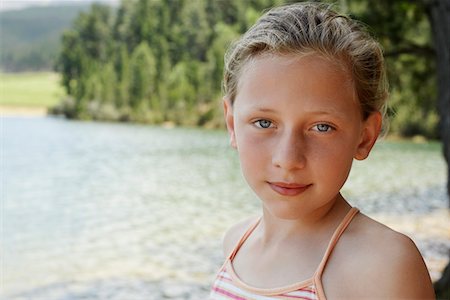 Girl (7-9) standing by lake, portrait. Stock Photo - Premium Royalty-Free, Code: 693-03686766