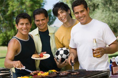 Four men at outdoor grill. Stock Photo - Premium Royalty-Free, Code: 693-03706956