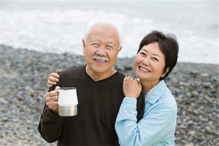 Senior couple at beach looking at camera Stock Photo - Premium Royalty-Free, Code: 693-03706974