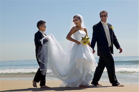 Bride and Groom with brother walking on beach Stock Photo - Premium Royalty-Free, Code: 693-03706980