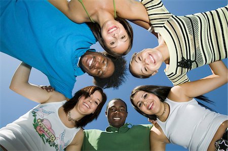 Group of friends in circle, view from below, portrait Stock Photo - Premium Royalty-Free, Code: 693-03706991