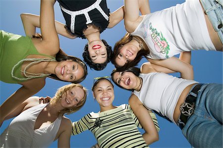 Group of friends in circle, view from below, portrait Stock Photo - Premium Royalty-Free, Code: 693-03706992