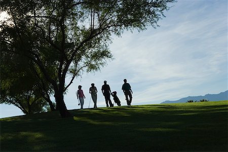 Silhouettes of group of golfers walking on golf course Stock Photo - Premium Royalty-Free, Code: 693-03707005