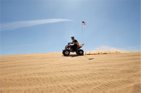quad biking - Young Man Riding ATV Over Sand Dune Stock Photo - Premium Royalty-Free, Code: 693-03707108