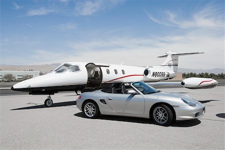 simsearch:693-05552680,k - Convertible and private jet on landing strip. Stock Photo - Premium Royalty-Free, Code: 693-03707194