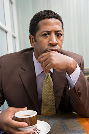 Businessman drinking coffee on business lunch Stock Photo - Premium Royalty-Free, Code: 693-03707215