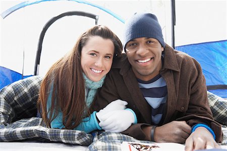 Young couple lying in sleeping bags in tent, portrait. Stock Photo - Premium Royalty-Free, Code: 693-03707231