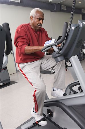 fit older black man in gym - Senior Man Exercising on Stationary Bike Stock Photo - Premium Royalty-Free, Code: 693-03707260