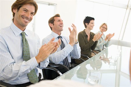 simsearch:693-03707355,k - Business colleagues applauding in business meeting Stock Photo - Premium Royalty-Free, Code: 693-03707338
