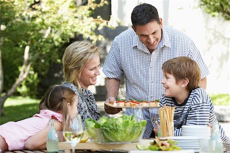 simsearch:693-03314791,k - Family of four having lunch outdoors, portrait Stock Photo - Premium Royalty-Free, Code: 693-03707525