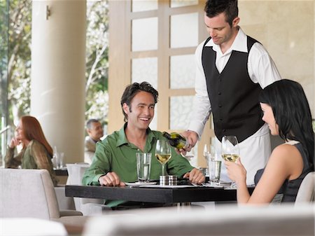 pouring drink bottle - Waiter pouring wine for couple at outdoor restaurant Stock Photo - Premium Royalty-Free, Code: 693-03707539
