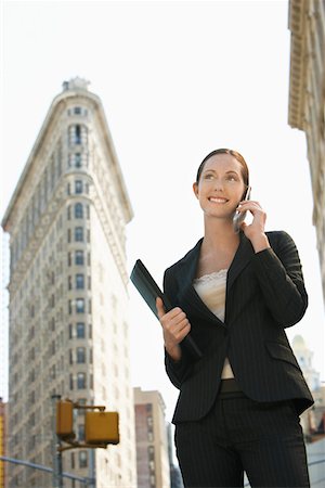 Businesswoman using mobile phone in street Stock Photo - Premium Royalty-Free, Code: 693-03707613