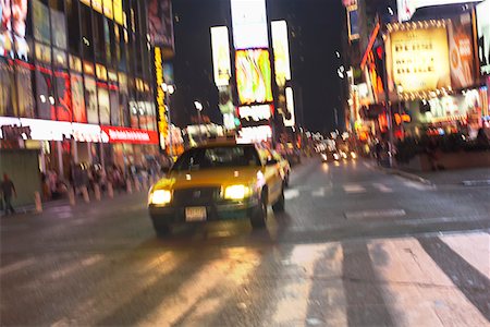Yellow Taxi on City Street at Night Stock Photo - Premium Royalty-Free, Code: 693-03707655