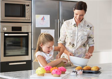 parents and children and cupcakes - Mother and Daughter Making Cupcakes in kitchen Stock Photo - Premium Royalty-Free, Code: 693-03707789