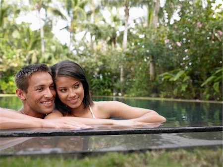 paradise scene - Young Couple Relaxing in Swimming Pool Stock Photo - Premium Royalty-Free, Code: 693-03707910
