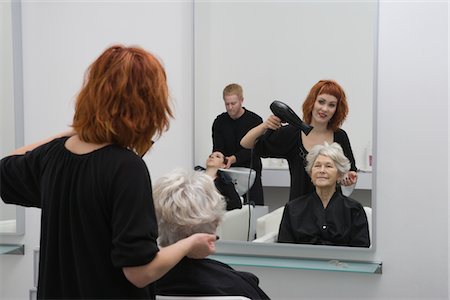 Stylist blow-drys elderly woman's hair Stock Photo - Premium Royalty-Free, Code: 693-03782596
