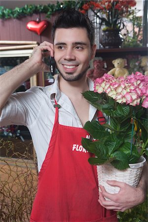 simsearch:693-03782738,k - Florist stands on mobile phone with  hydrangea Foto de stock - Sin royalties Premium, Código: 693-03782735