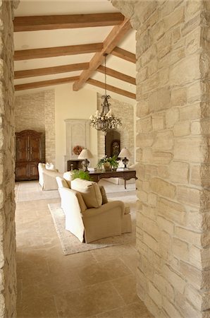 doorway - Looking into a living room with furniture and wooden beams Stock Photo - Premium Royalty-Free, Code: 693-03782930