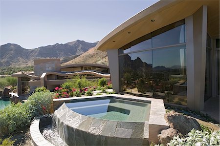 expensive houses exterior - Exterior of a modern house with a small pool and mountains in the background Stock Photo - Premium Royalty-Free, Code: 693-03782944