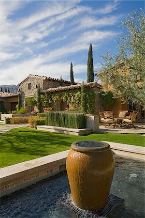 pot modern - Exterior of a house,with a garden,plants and a water feature Stock Photo - Premium Royalty-Free, Code: 693-03782976