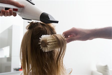 female hair stylist - A young woman having her hair dried in the hairdressers Stock Photo - Premium Royalty-Free, Code: 693-03783014