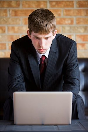 furrowed brow - Businessman Working on Laptop Stock Photo - Rights-Managed, Code: 700-04163445