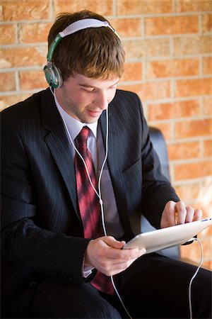 enjoy ipad - Businessman Using iPad Stock Photo - Rights-Managed, Code: 700-04163448