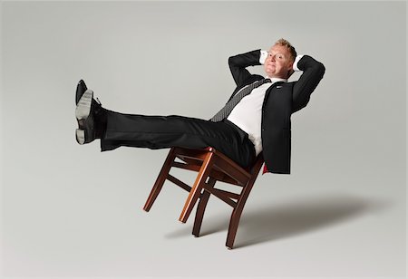 récliner - Homme d'affaires s'appuyant sur chaise Photographie de stock - Rights-Managed, Code: 700-05452213