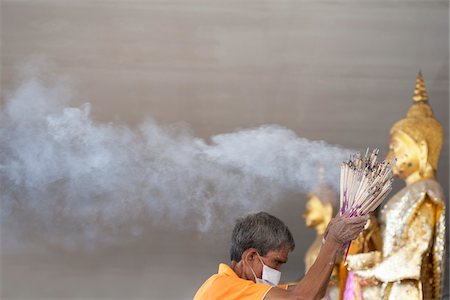 Temple Worker Collecting Lit Incense, Wat Petsamut Woravihara, Maeklong, Samut Songkram, Thailand Stock Photo - Rights-Managed, Code: 700-05653171