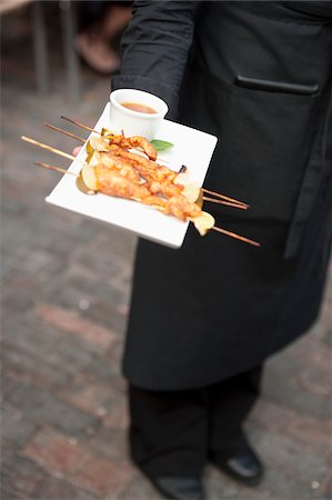 serving food at restaurant - Waiter with Tray of Chicken Satay Stock Photo - Rights-Managed, Code: 700-05786695