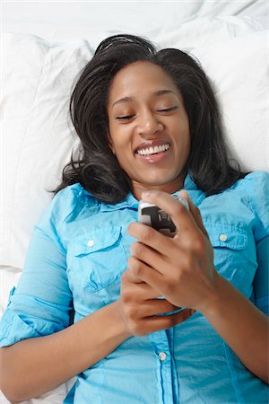 Woman Using Phone in Bed Stock Photo - Rights-Managed, Code: 700-05803559