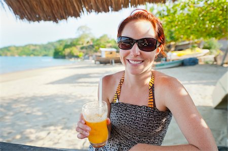 Woman with Mango Drink on Beach, near Paraty, Rio de Janeiro, Brazil Stock Photo - Rights-Managed, Code: 700-05947863