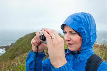 raincoat hood - Woman Taking Photograph, Ilha do Mel, Parana, Brazil Stock Photo - Rights-Managed, Code: 700-05947891