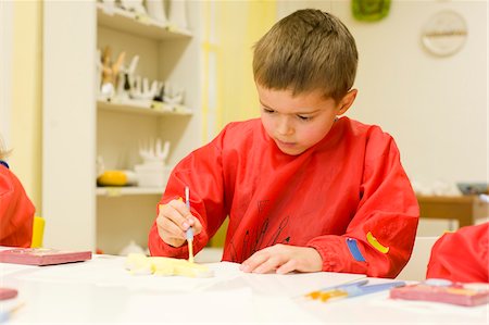 Boy Painting Clay Figure Foto de stock - Con derechos protegidos, Código: 700-05969970