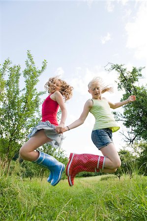 preteen skirts - Two Girls Jumping Stock Photo - Rights-Managed, Code: 700-05973440