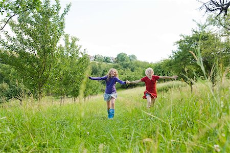 preteens in skirts - Two Girls Running in Field Stock Photo - Rights-Managed, Code: 700-05973505