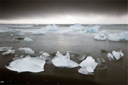 Icebergs Grounded on Snow Covered Volcanic Beach during Storm, Jokulsarlon, Iceland Stock Photo - Rights-Managed, Code: 700-06059825