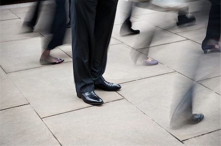 Businessman Standing Still Amongst Pedestrian Traffic Stock Photo - Rights-Managed, Code: 700-06325342