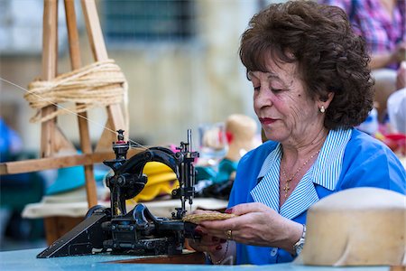 sewing machine woman - Woman Using Sewing Machine at Artisan Fair in Corsini Gardens, Florence, Tuscany, Italy Stock Photo - Rights-Managed, Code: 700-06334779