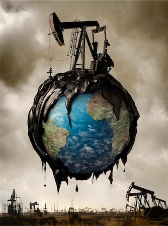 digitally altered - Huile couvert le Globe en vol stationnaire au-dessus de champs pétrolifères Photographie de stock - Rights-Managed, Code: 700-06368066