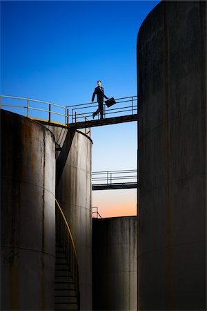 refinery inspection - Businessman Crossing Catwalk Between Storage Tanks Stock Photo - Rights-Managed, Code: 700-06368072
