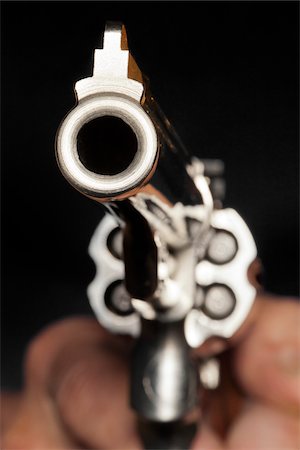 Close-Up of Man Aiming Gun Foto de stock - Con derechos protegidos, Código: 700-06383880