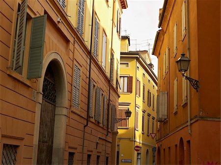 orange and yellow four storey buildings with shuttered windows line narrow streets, Modena, Emilia-Romagna, Italy Stock Photo - Rights-Managed, Code: 700-06452072