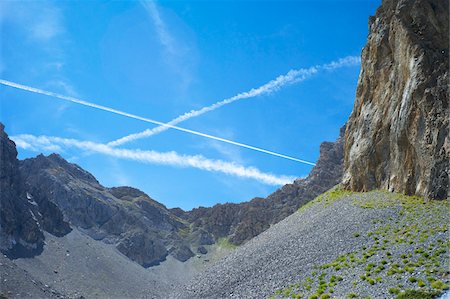 Jet Contrails in Blue Sky over Mountain Frontier between France and Italy, Stroppo, Italy Stock Photo - Rights-Managed, Code: 700-06452157