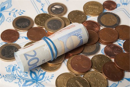 patterned tablecloth - Roll of European Bills on top of Euro Coins Stock Photo - Rights-Managed, Code: 700-06465383