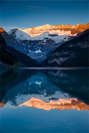 reflecting in water - Lake Louise at Dawn, Banff National Park, Alberta, Canada Stock Photo - Rights-Managed, Code: 700-06465420
